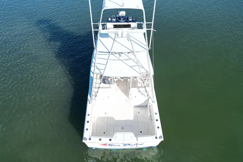 Slide: The Image of Aerial view of a 1996 Cabo 35 Express boat on calm water. - 3