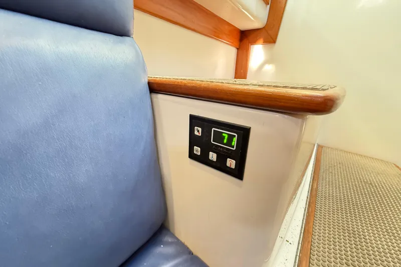 Slide: The Image of Interior of 1996 Cabo 35 Express boat with digital control panel and blue seating. - 30