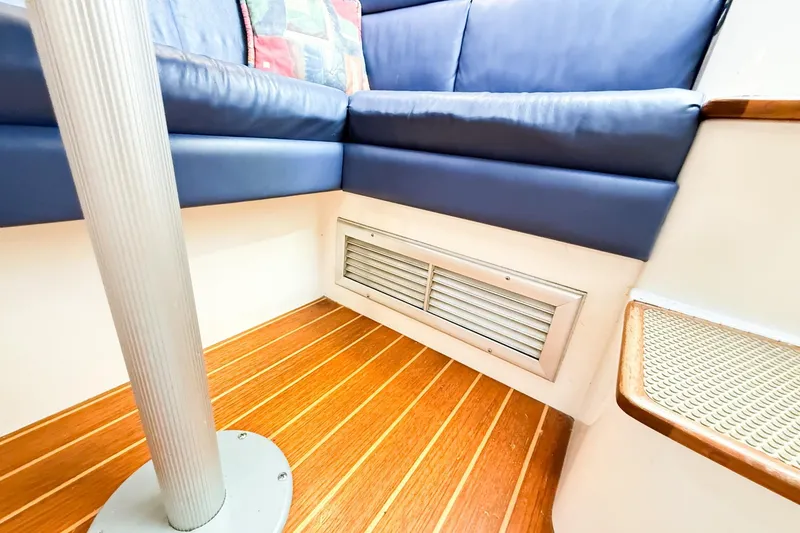 Slide: The Image of Interior of 1996 Cabo 35 Express boat with blue seating and wooden flooring. - 32