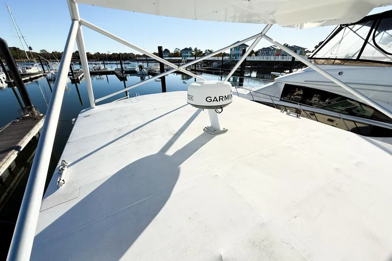 Slide: The Image of 1996 Cabo 35 Express boat with Garmin radar at marina dock. - 35