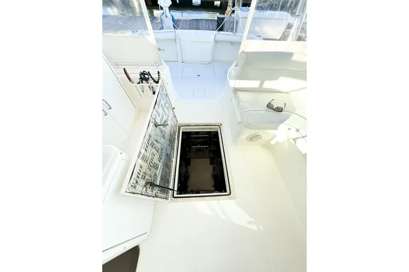 Slide: The Image of 1996 Cabo 35 Express boat interior with open hatch and seating area. - 36