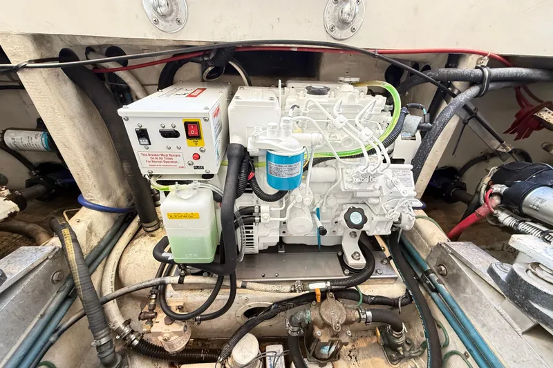 Slide: The Image of Engine compartment of a 1996 Cabo 35 Express boat, showcasing mechanical components. - 39