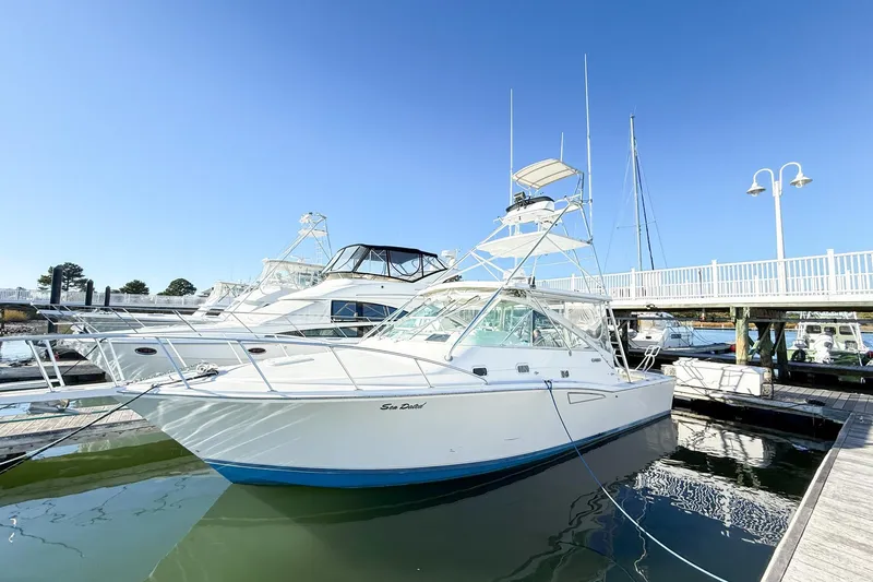 Slide: The Image of 1996 Cabo 35 Express boat docked at marina under clear blue sky. - 4