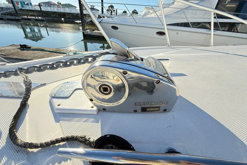 Slide: The Image of Chrome anchor winch on 1996 Cabo 35 Express boat deck, docked at marina. - 40