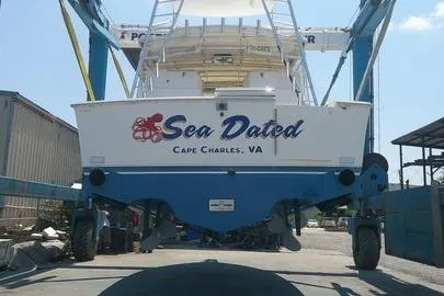 Slide: The Image of 1996 Cabo 35 Express boat named "Sea Dated" in Cape Charles, VA, on a lift. - 9