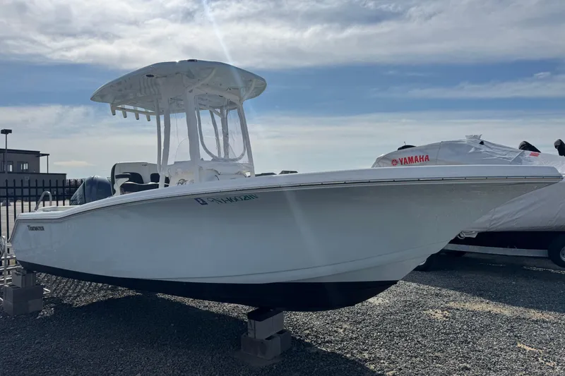 Slide: The Image of 2025 Tidewater 220 LXF boat with Yamaha engine, displayed outdoors. - 1