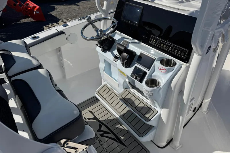 Slide: The Image of 2025 Tidewater 220 LXF boat cockpit with modern controls and seating. - 11