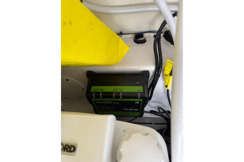 Slide: The Image of Battery charger setup in 2025 Tidewater 220 LXF boat interior. - 14