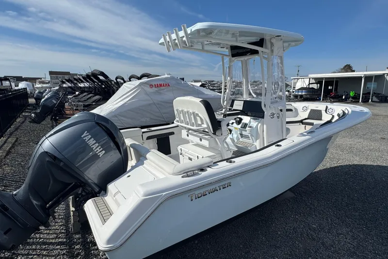Slide: The Image of 2025 Tidewater 220 LXF boat with Yamaha engine, parked outdoors under clear sky. - 4