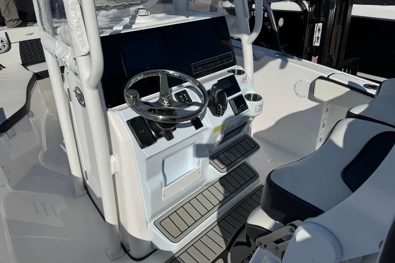Slide: The Image of 2025 Tidewater 220 LXF boat cockpit with steering wheel and control panel. - 5
