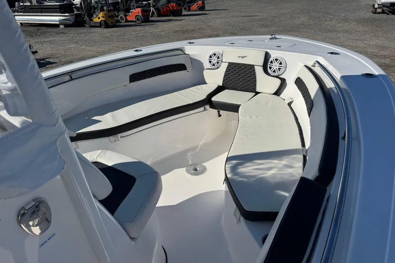 Slide: The Image of 2025 Tidewater 220 LXF boat interior with cushioned seating and modern design. - 6