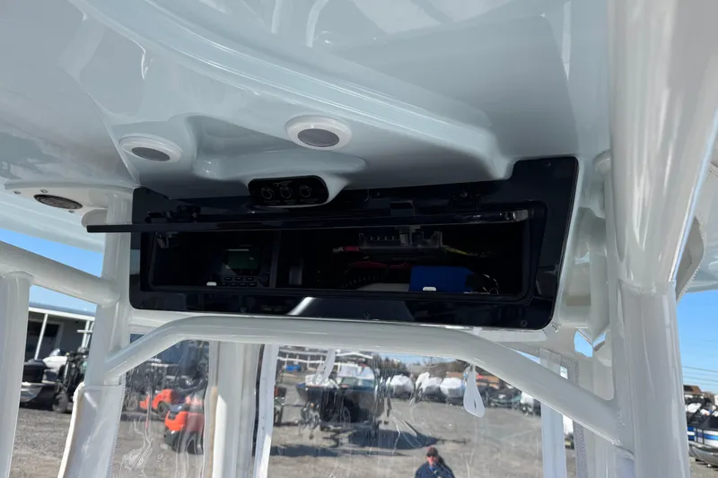 Slide: The Image of 2025 Tidewater 220 LXF boat console with open electronics compartment. - 8
