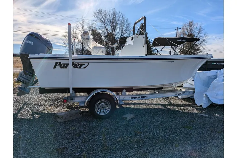 The Image of 2025 Parker 18SE Center Console boat on trailer with Yamaha engine, outdoor setting. - 0