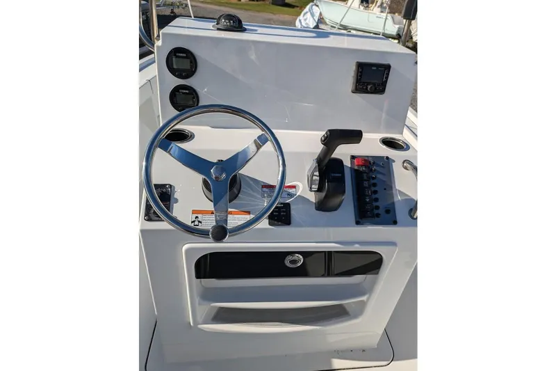 Slide: The Image of 2025 Parker 18SE Center Console boat dashboard with steering wheel and controls. - 2