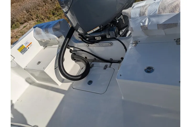 Slide: The Image of 2025 Parker 18SE Center Console boat interior with engine and storage compartments. - 6