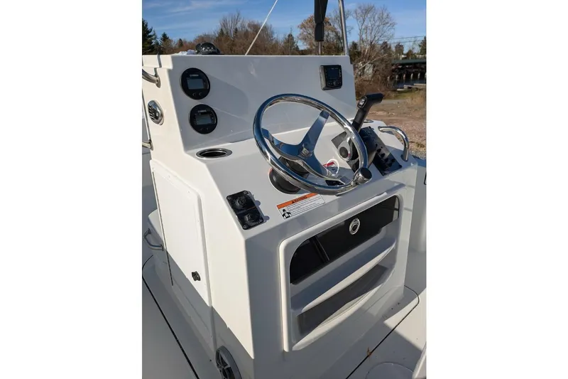 Slide: The Image of 2025 Parker 18SE Center Console boat steering wheel and dashboard controls. - 7