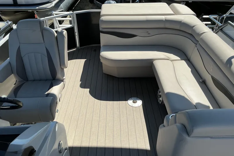 Slide: The Image of 2018 Bennington SX 21 SLXP pontoon boat interior with plush seating and steering console. - 10