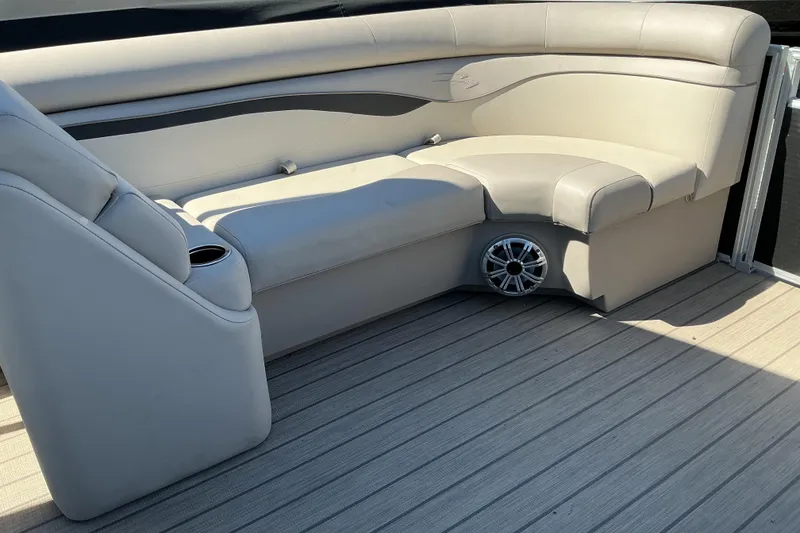 Slide: The Image of 2018 Bennington SX 21 SLXP boat interior with beige seating and speaker. - 11