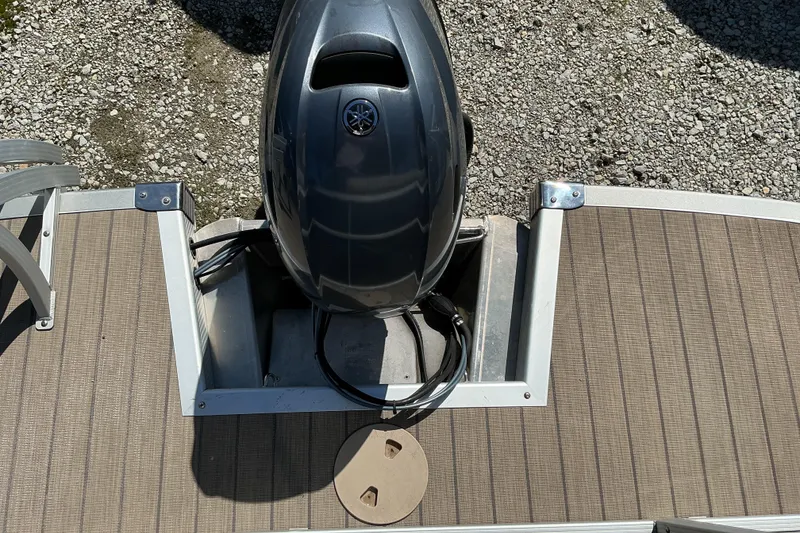 Slide: The Image of 2018 Bennington SX 21 SLXP boat with Yamaha outboard motor on gravel surface. - 14