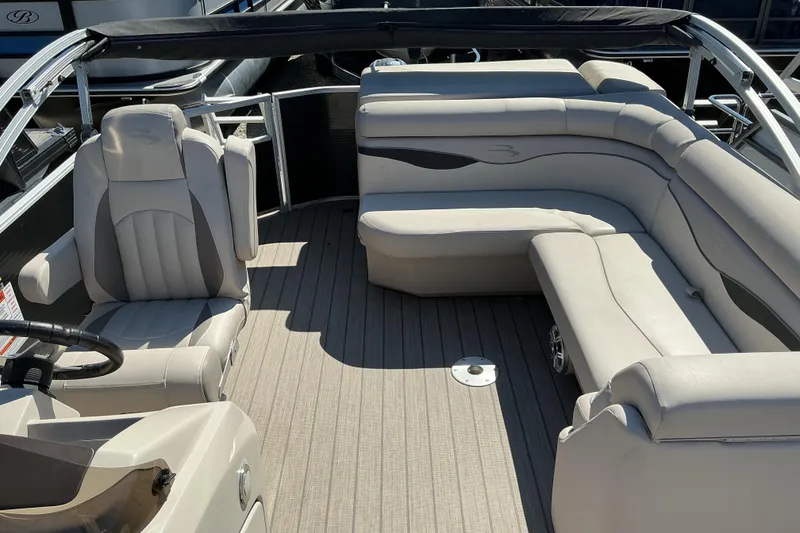 Slide: The Image of 2018 Bennington SX 21 SLXP pontoon boat interior with plush seating and steering console. - 16
