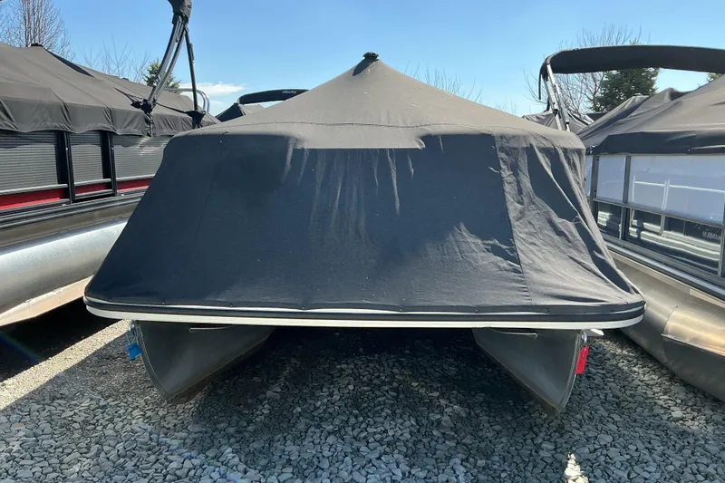 Slide: The Image of 2018 Bennington SX 21 SLXP pontoon boat with cover, parked on gravel. - 17