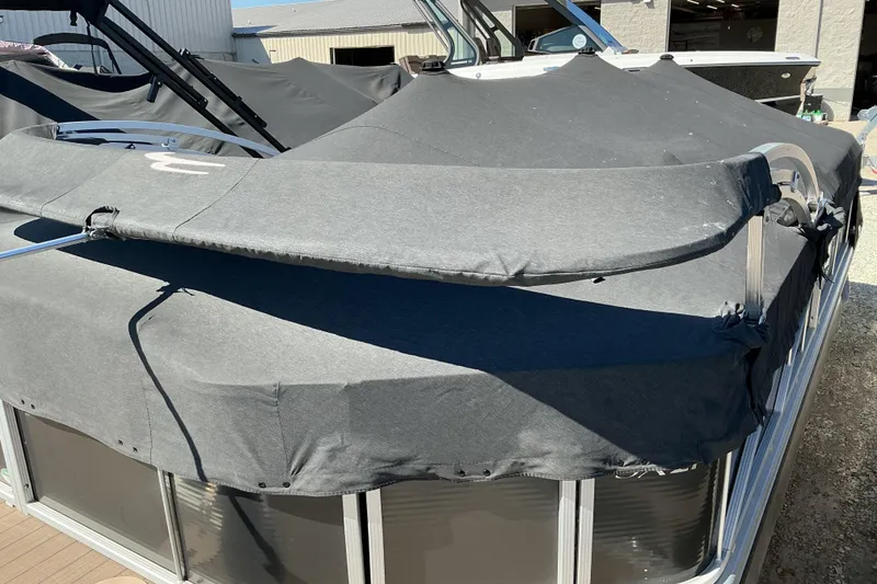 Slide: The Image of 2018 Bennington SX 21 SLXP pontoon boat with protective cover in outdoor storage. - 19