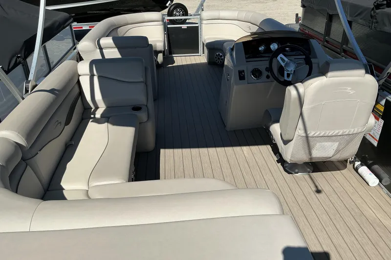 Slide: The Image of 2018 Bennington SX 21 SLXP pontoon boat interior with beige seating and steering console. - 6