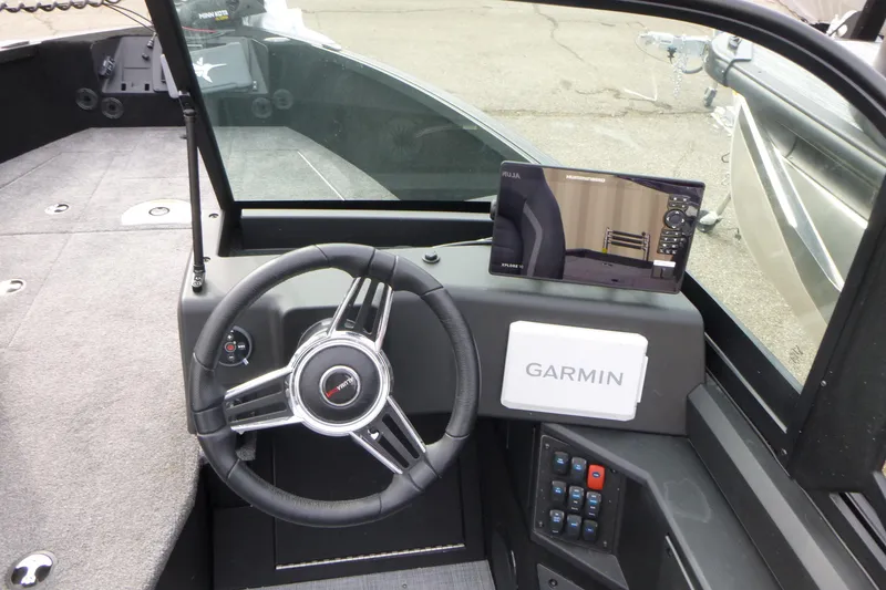 Slide: The Image of 2025 Alumacraft Competitor 175X Sport dashboard with Garmin navigation system and steering wheel. - 10