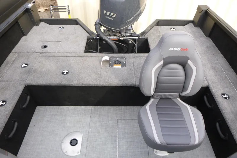 Slide: The Image of 2025 Alumacraft Competitor 175X Sport boat interior with Yamaha 115 engine and cushioned seat. - 13