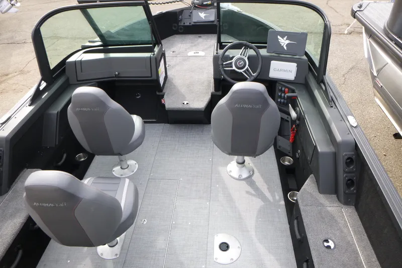 Slide: The Image of 2025 Alumacraft Competitor 175X Sport interior with seating and Garmin navigation system. - 3