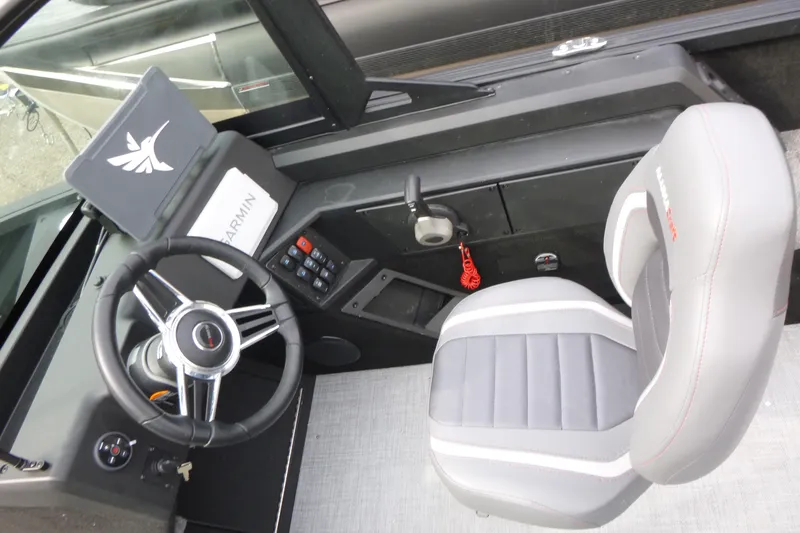 Slide: The Image of 2025 Alumacraft Competitor 175X Sport boat cockpit with steering wheel and Garmin navigation system. - 9