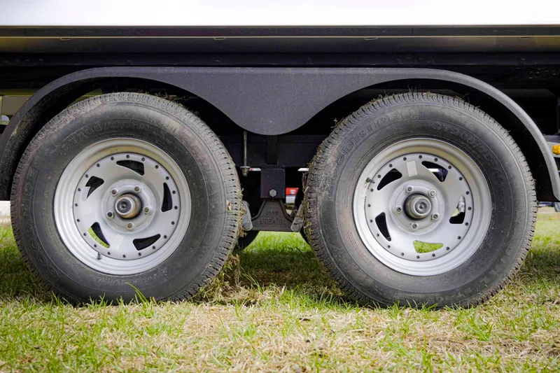 Slide: The Image of Dual wheels of a 2025 SunCatcher Fusion 322RC trailer on grass. - 10