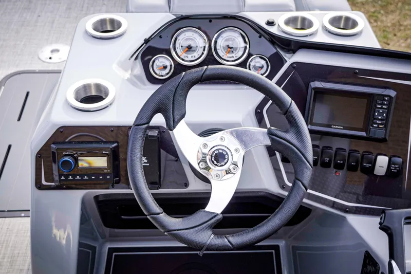 Slide: The Image of Steering console of 2025 SunCatcher Fusion 322RC boat with gauges and controls. - 13