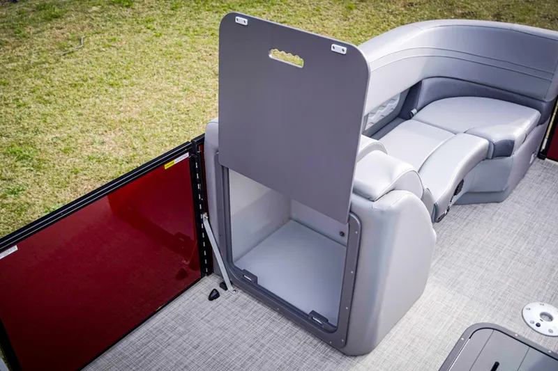 Slide: The Image of 2025 SunCatcher Fusion 322RC boat interior with gray seating and storage compartment. - 26