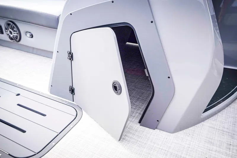 Slide: The Image of Open storage compartment on 2025 SunCatcher Fusion 322RC boat, showcasing sleek design. - 28