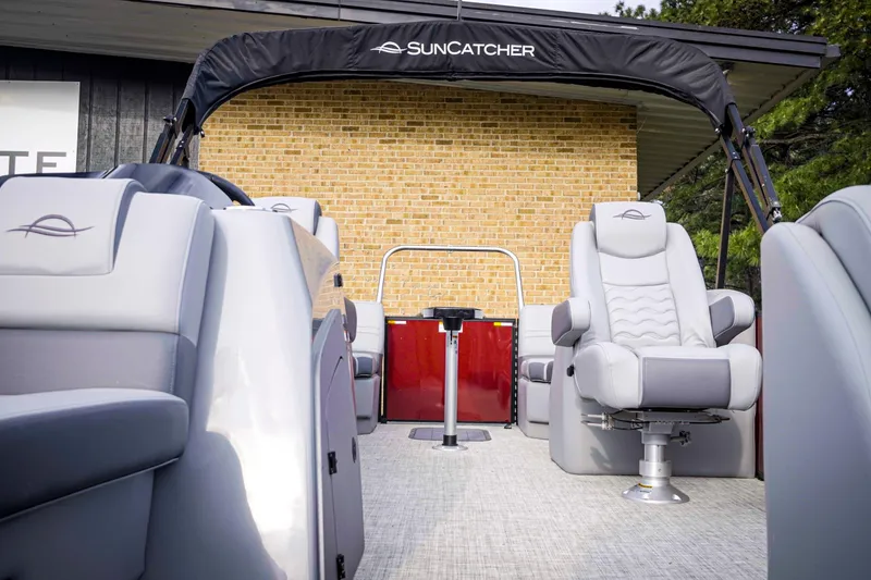 Slide: The Image of 2025 SunCatcher Fusion 322RC boat interior with plush seating and canopy. - 29