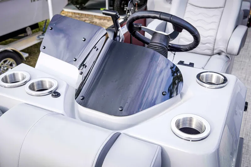 Slide: The Image of Steering console of 2025 SunCatcher Fusion 322RC boat with cup holders. - 30