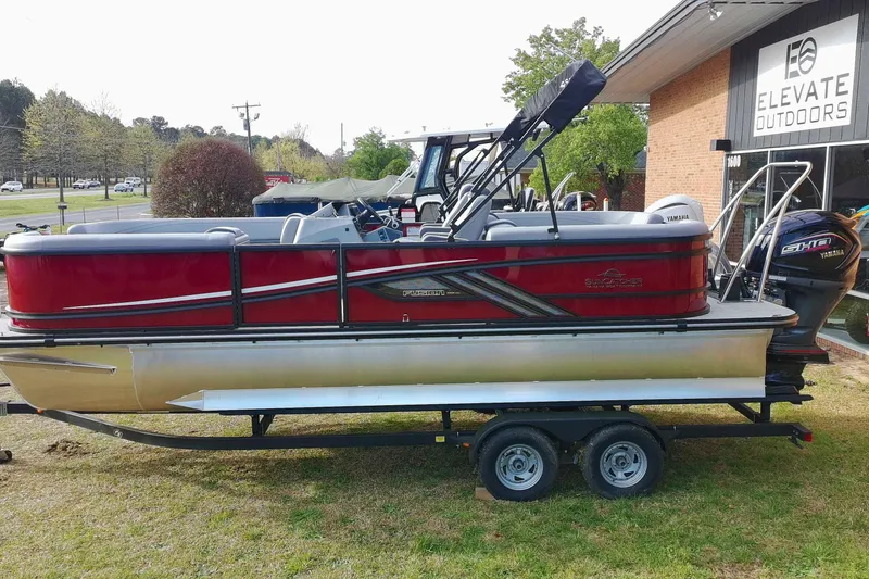 Slide: The Image of 2025 SunCatcher Fusion 322RC pontoon boat on trailer, displayed outdoors. - 32