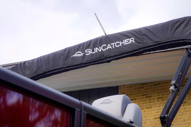 Slide: The Image of 2025 SunCatcher Fusion 322RC boat canopy with logo, showcasing sleek design. - 6