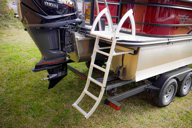 Slide: The Image of 2025 SunCatcher Fusion 322RC boat with Yamaha motor and ladder on trailer. - 8