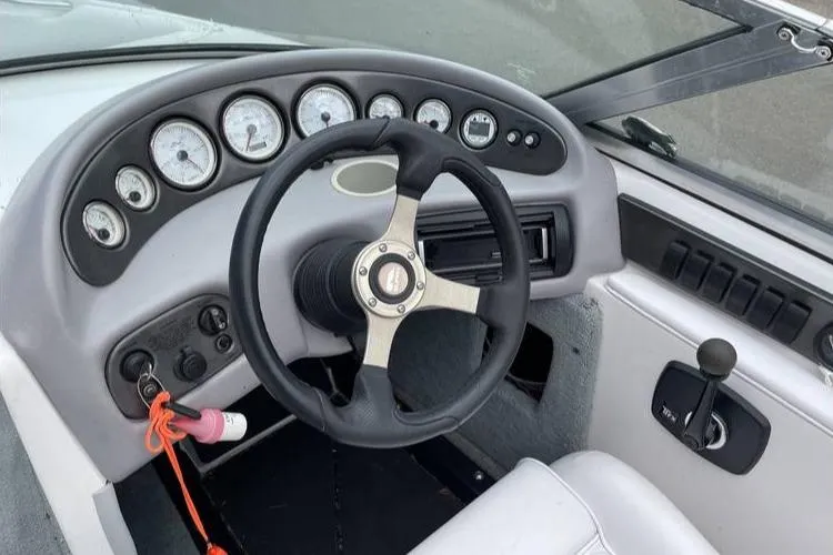 Slide: The Image of 2001 Supra Legacy boat dashboard with steering wheel and gauges. - 5