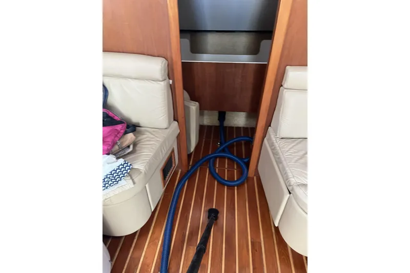 Slide: The Image of Interior of 2002 Tiara Yachts 4300 Open with wooden flooring and beige seating. - 14