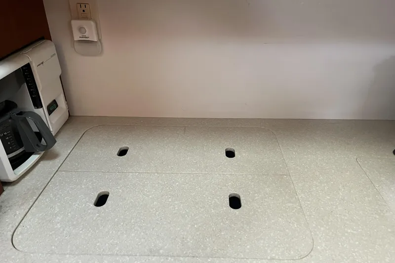 Slide: The Image of Countertop with built-in stove covers on a 2002 Tiara Yachts 4300 Open. - 19