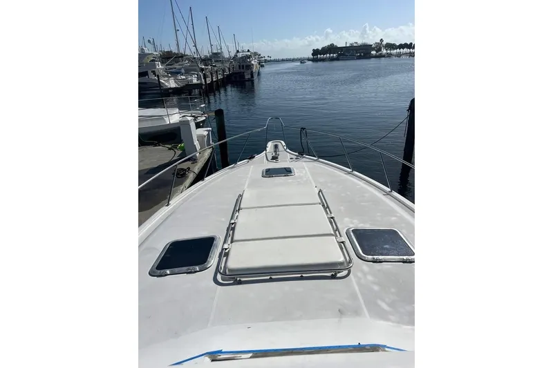 Slide: The Image of 2002 Tiara Yachts 4300 Open docked at marina, view from bow. - 2