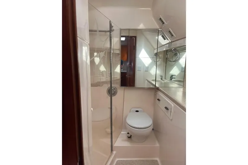 Slide: The Image of Bathroom interior of 2002 Tiara Yachts 4300 Open, featuring shower and toilet. - 21