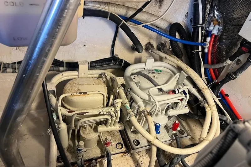 Slide: The Image of Engine room of a 2002 Tiara Yachts 4300 Open, showcasing complex wiring and machinery. - 22