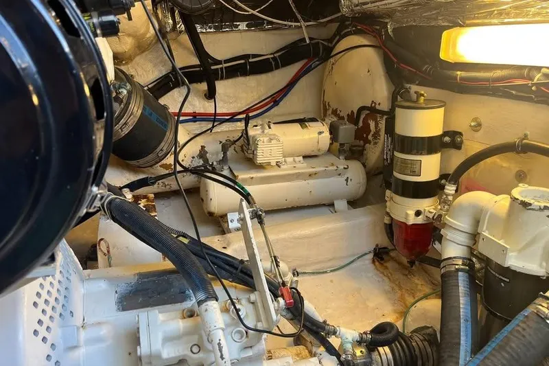 Slide: The Image of Engine room of a 2002 Tiara Yachts 4300 Open, showcasing mechanical components and wiring. - 25