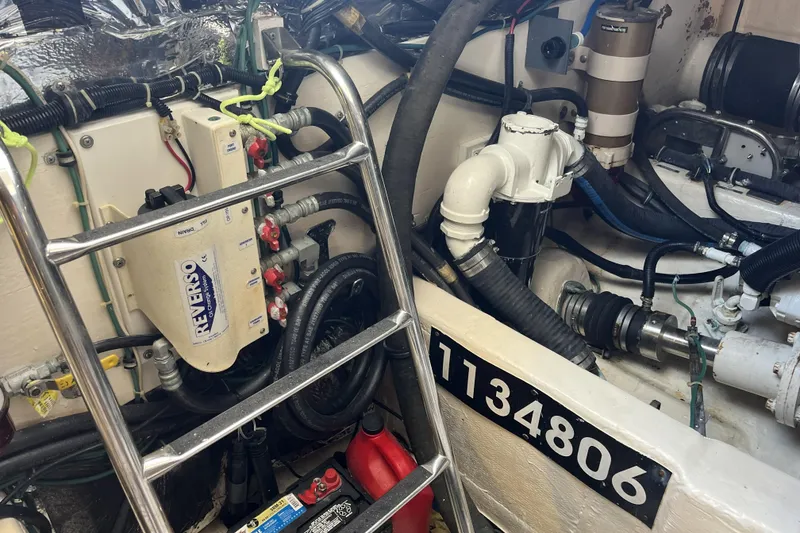 Slide: The Image of Engine room of 2002 Tiara Yachts 4300 Open, featuring mechanical components and a ladder. - 27