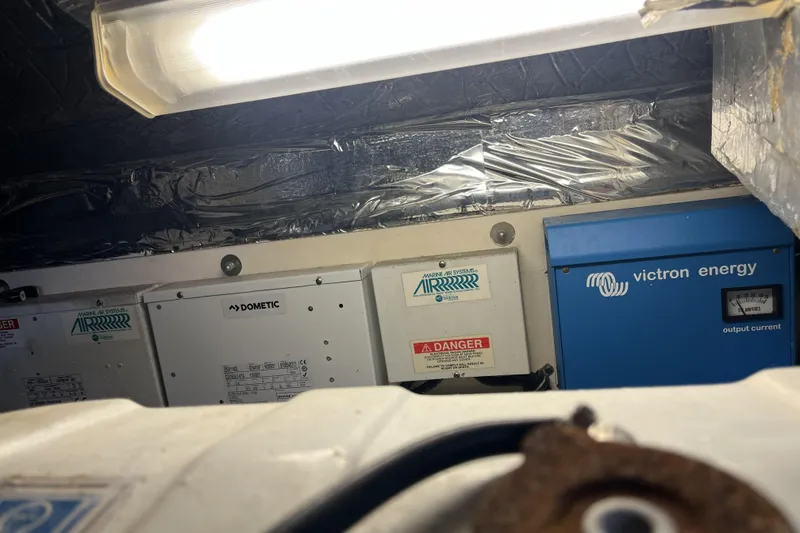 Slide: The Image of Electrical components inside a 2002 Tiara Yachts 4300 Open, featuring Victron Energy equipment. - 28
