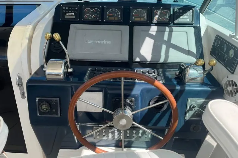 Slide: The Image of Helm of 2002 Tiara Yachts 4300 Open with wooden steering wheel and control panel. - 3